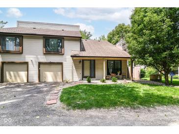 Inviting two-story townhome with attached garage and well-maintained front lawn at 2433 Hideaway S Dr, Indianapolis, IN 46268