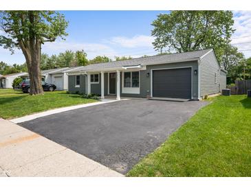 Charming ranch-style home with a well-manicured lawn, a driveway, and an attached one car garage at 2537 N Boehning St, Indianapolis, IN 46219