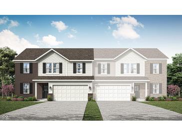New two-story townhome with a brick facade, symmetrical windows, and an attached two-car garage at 2946 Woods Edge Dr, Greenwood, IN 46143