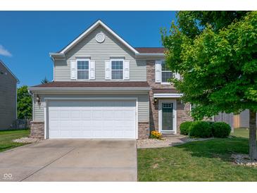 Two-story home featuring a two car garage, neutral siding and partial stone accents plus manicured lawn at 3010 Underwood Ct, Whiteland, IN 46184