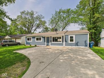 Charming single-story home with a large driveway and well-maintained lawn at 4020 N Mitthoefer Rd, Indianapolis, IN 46235