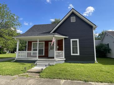 Charming two-story home with a welcoming front porch and a well-maintained lawn, perfect for curb appeal at 421 W Hendricks St, Shelbyville, IN 46176