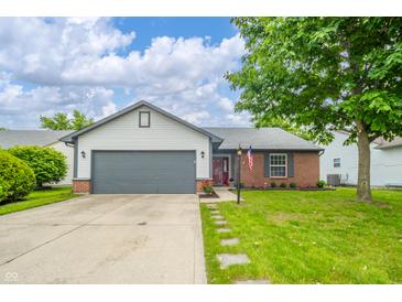Charming single-story home featuring a well-manicured lawn, gray garage door, and a lovely brick facade at 441 E Pine Ridge Dr, Westfield, IN 46074