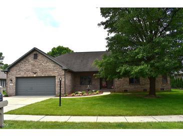 Charming brick home with a well-manicured lawn and mature trees, creating great curb appeal at 4723 Goldenrain Ct, Indianapolis, IN 46237