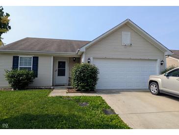 Charming single-story home featuring a two-car garage and a well-manicured lawn at 581 Grassy Bend Dr, Greenwood, IN 46143