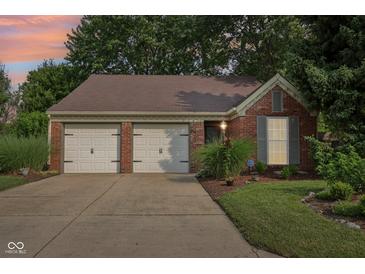 Charming single-story brick home featuring a two-car garage and well-maintained landscaping at 6760 Navigate Way, Indianapolis, IN 46250