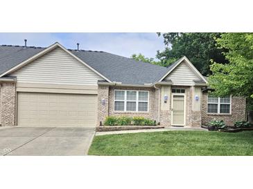 Charming brick home with well-manicured lawn and an attached garage, perfect for suburban living at 6956 Park Square Dr # D, Avon, IN 46123