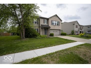 Charming two-story home with brick accents, attached garage, and well-manicured lawn at 7657 Wheatgrass Ln, Noblesville, IN 46062