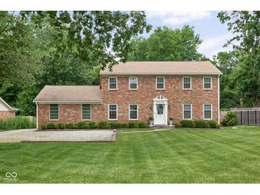Charming brick two-story home featuring manicured lawn and inviting entrance at 8436 N Meridian St, Indianapolis, IN 46260