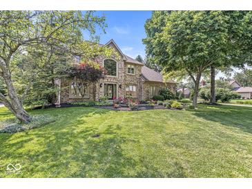 Charming two-story brick home with manicured lawn and lush landscaping at 8712 Admirals Bay Dr, Indianapolis, IN 46236