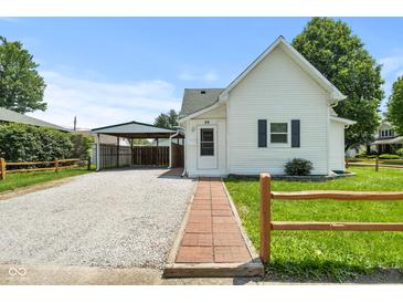 Charming home showcasing a well-manicured lawn and a convenient carport at 89 S Grant St, Martinsville, IN 46151