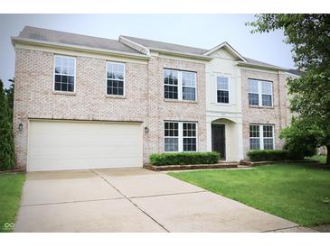 Charming two-story brick home with a well-manicured lawn and a two-car garage at 10501 Morning Song Dr, Fishers, IN 46038