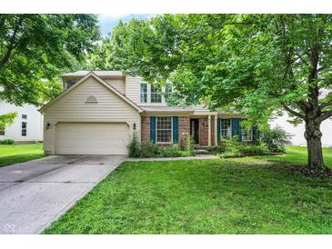 Charming two-story home with a well-manicured lawn and attached two-car garage in a quiet neighborhood at 1264 Black Oak Dr, Greenwood, IN 46143