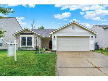 Charming single-Gathering home with a well-manicured lawn and two car garage on a sunny day at 15523 Follow Dr, Noblesville, IN 46060