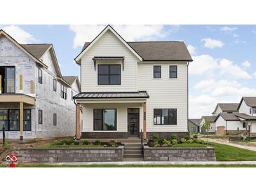 Charming two-story home with a white exterior, landscaped front yard, and covered porch at 1654 Fernley Dr, Westfield, IN 46074