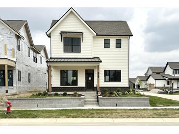 Charming two-story home boasts a modern farmhouse design and welcoming curb appeal with landscaped front yard at 1654 Fernley Dr, Westfield, IN 46074