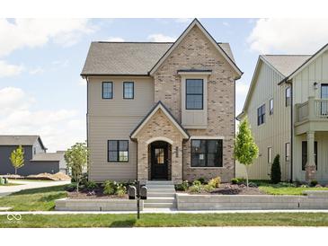 Charming two-story home featuring mixed brick and siding, professional landscaping and inviting entryway at 1655 Carrollton Rail Dr, Westfield, IN 46074