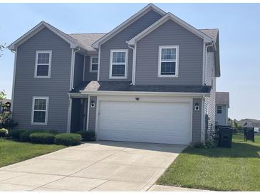 Charming two-story home featuring gray siding, manicured lawn, and a two-car garage at 2253 Jaybird Dr, Greenfield, IN 46140
