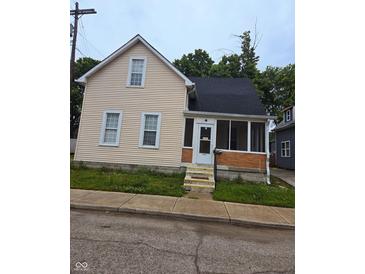 Charming two-story home with siding and an enclosed porch in a residential neighborhood at 352 W 28Th St, Indianapolis, IN 46208