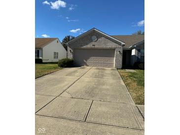 Charming one-story home with a brick facade, two-car garage, and a well-maintained front yard at 3682 Lace Bark Dr, Indianapolis, IN 46235