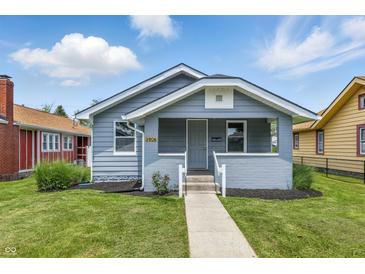 Charming bungalow featuring a cozy front porch, landscaped yard, and well-maintained exterior in a residential neighborhood at 3906 Fletcher Ave, Indianapolis, IN 46203