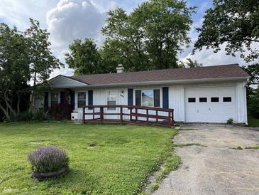 Charming single-story home with a well-maintained front yard, blue shutters, and attached garage at 516 Memorial Dr, Edinburgh, IN 46124