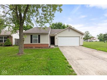 Charming single-story home with a well-maintained lawn and two-car garage at 6227 Long River Ln, Indianapolis, IN 46221