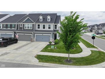 Charming townhome with a two-car garage, manicured lawn, and inviting curb appeal at 640 Axford Bay Dr, Westfield, IN 46074