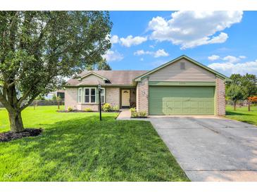 Charming single-story home with a well-maintained lawn, a two-car garage, and colorful landscaping at 6842 Sextant Dr, Indianapolis, IN 46260