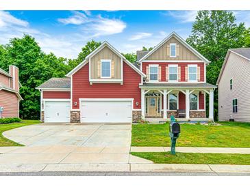 Charming two-story home featuring a well-manicured lawn and a spacious three-car garage at 749 Bracknell Dr, Avon, IN 46123