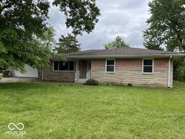 Charming single-story home featuring a stone and brick facade and a well-manicured front lawn at 8045 Briarwood Dr, Indianapolis, IN 46227