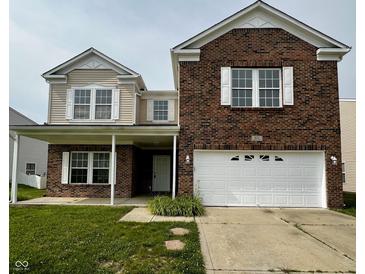 Charming two-story brick home featuring a covered front porch and a two-car garage at 832 Spinney Ln, Whiteland, IN 46184