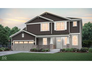 Charming two-story home with gray and brown siding, a brick facade, and an attached two-car garage at 864 Cowley Dr, Westfield, IN 46074