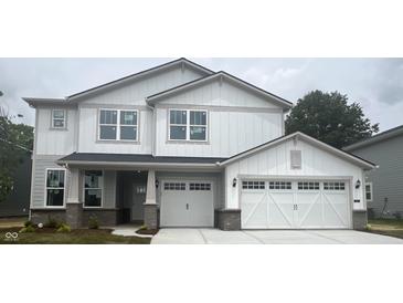 Charming two-story home featuring a two-car garage, white siding, and a welcoming front porch at 864 Cowley Dr, Westfield, IN 46074