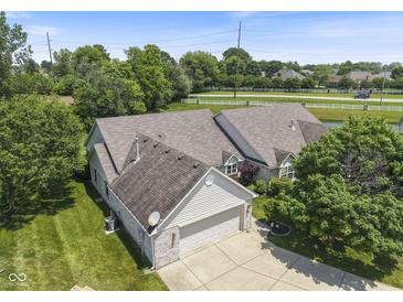 A stunning aerial view of a house featuring a brick exterior, lush landscaping, and a well-manicured lawn at 10934 Harness Ct, Indianapolis, IN 46239