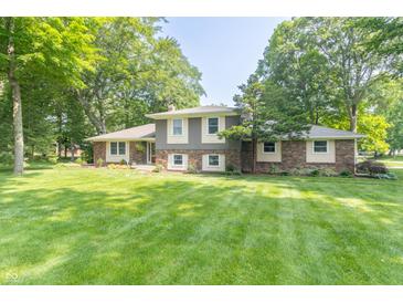 Charming brick and siding home with mature trees and a well-maintained lawn at 12014 Briar Way Center Dr, Indianapolis, IN 46126