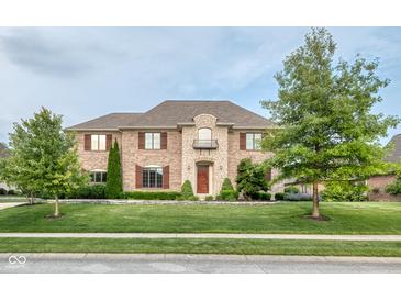 Stunning brick home featuring manicured lawn, stone accents, and beautiful curb appeal at 13429 Boxelder Ct, Carmel, IN 46074