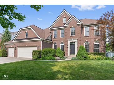 Beautiful two-story brick home featuring a well-manicured lawn and a two-car garage at 15515 Alameda Pl, Westfield, IN 46074