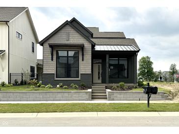 Charming single-Gathering home featuring mixed siding, professionally landscaped yard and a welcoming front entry at 1663 Fernley Dr, Westfield, IN 46074