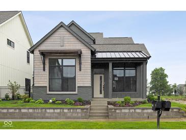 Charming home featuring a mixed material facade, inviting entrance, and professionally landscaped yard at 1663 Fernley Dr, Westfield, IN 46074