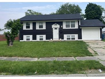 Two story home featuring a dark exterior and white shutters with an attached garage at 3949 Chateau Dr, Indianapolis, IN 46226
