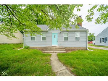 Charming single-story home with light gray siding and a welcoming turquoise front door at 5516 W Minnesota St, Indianapolis, IN 46241