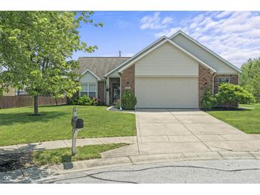 Charming brick and vinyl home featuring an attached two-car garage, landscaped lawn, and concrete driveway at 6529 Lakesedge Dr, Indianapolis, IN 46237