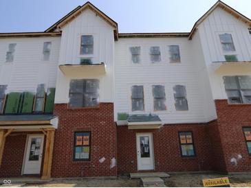 Modern townhome exterior featuring brick and white siding, and multiple windows at 7063 Pate Hollow Dr, Brownsburg, IN 46112
