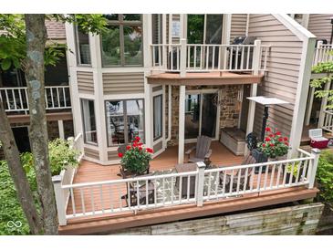 An outdoor deck featuring a seating area and grill provides an outdoor living and dining experience at 8133 Lower Bay Ln, Indianapolis, IN 46236
