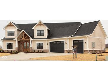 Charming two-story home with a two-car garage, stylish wooden door and modern architectural details at O Legacy Estates-Lot 5, Mooresville, IN 46158