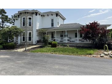 Charming two-story home with stone accents and a welcoming front porch at 115 W State Road 38, Pendleton, IN 46064