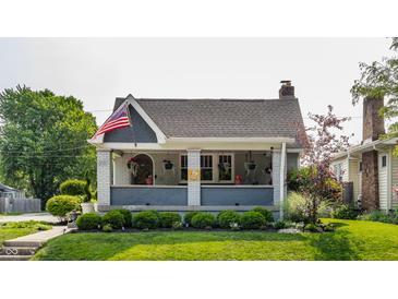 Charming home featuring a inviting front porch and manicured landscaping at 1437 Shannon Ave, Indianapolis, IN 46201