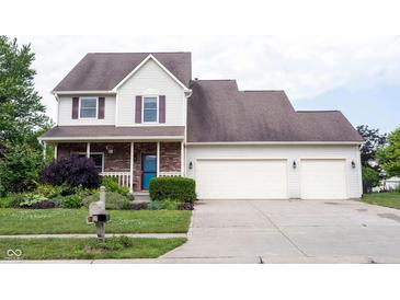 Charming two-story home featuring a two-car garage, well-manicured lawn, and a welcoming front porch at 1477 Macintosh Ct, Avon, IN 46123