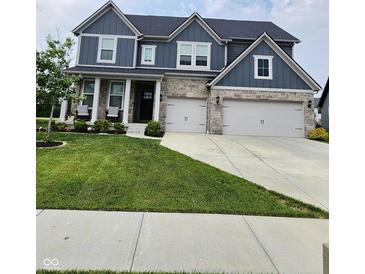 Beautiful two-story home with a well-manicured lawn and a three-car garage at 15873 Hush Hickory Bnd, Westfield, IN 46074
